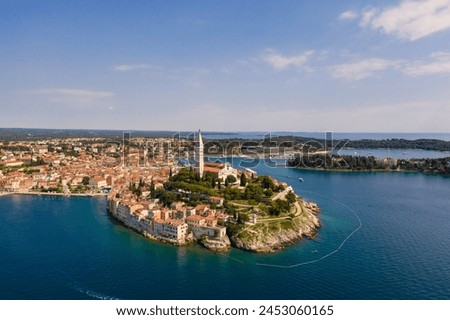 Rovinj, Croatia: Dramatic aerial view of the famous Rovinj medieval old town with its Venetian campanile in Istria by the Adriatic sea in Croatia Royalty-Free Stock Photo #2453060165