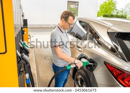 The driver fills up expensive gasoline in self-service filling station in Europe. High quality photo