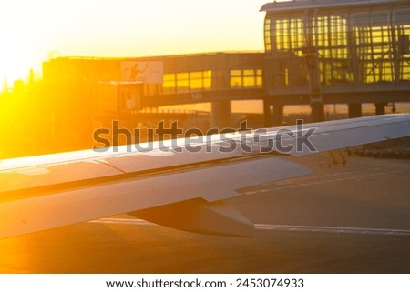 Airplane wing with first light of morning Royalty-Free Stock Photo #2453074933