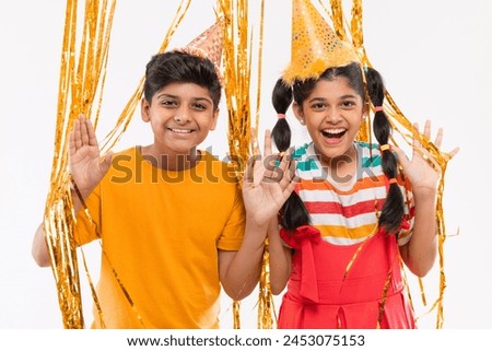 Cheerful boy and girl celebrating birthday together against white background