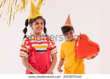 Cheerful boy and girl celebrating birthday together