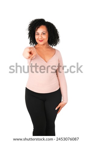 Beautifull young arab woman with curly hair pointing her finger against a white background