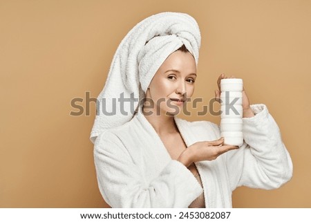 A woman in a robe showcases her natural beauty while holding a tube of cream.