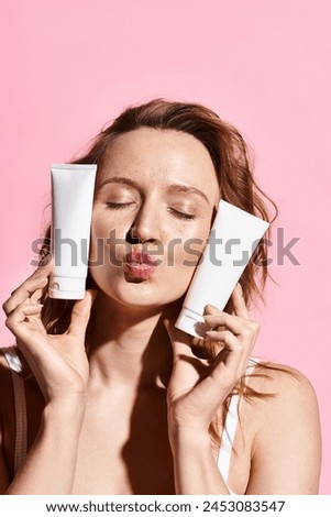 A beautiful woman actively applies cream from two tubes onto her face to enhance her natural beauty.