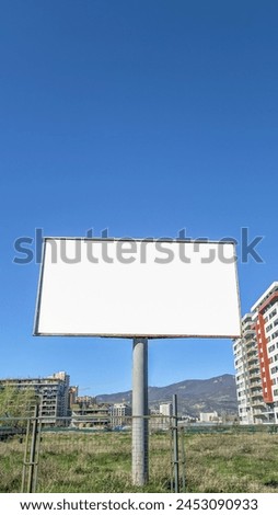 Large blank billboard  against   urban construction 
