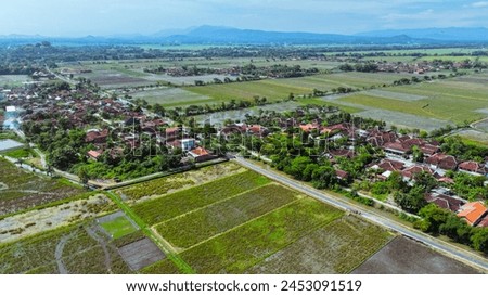 Rice field Nature Landscape photography.
Tropical rural landscape with simple rustic hut.
green landscape with blue and grey sky and mountains in the Indonesia.