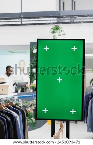 Interactive board with chroma key display for advertisement and shoes showcasing for customers in clothing store. Smart green screen for promotion mock up in shopping mall