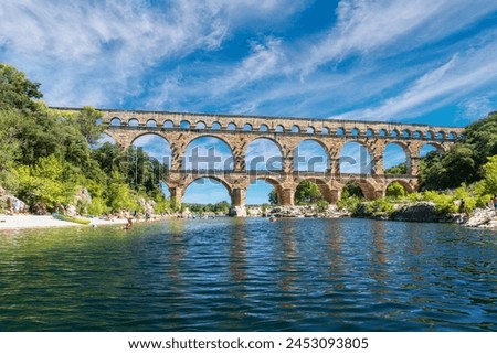 The Pont du Gard is an ancient Roman aqueduct, that is depicted  on five euro note. Summer 2022. Royalty-Free Stock Photo #2453093805