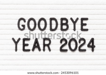 Black color letter in word goodbye year 2024 on white felt board background