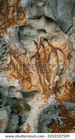 Prehistoric petroglyph rock paintings in Raja Ampat, Southwest Papua, Indonesia. Aborigines from Australia left their markings in the form of rock paintings around Misool Island. 3,000 to 5,000 years.