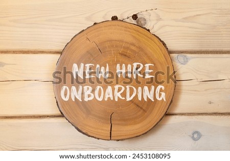 New hire onboarding symbol. Concept words New hire onboarding on beautiful wooden circle. Beautiful wooden wall background. Business new hire onboarding concept. Copy space.
