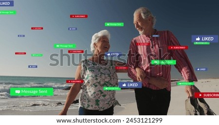 Image of social media text and icons over senior caucasian couple on beach. Global social media, digital interface, computing and data processing concept digitally generated image.