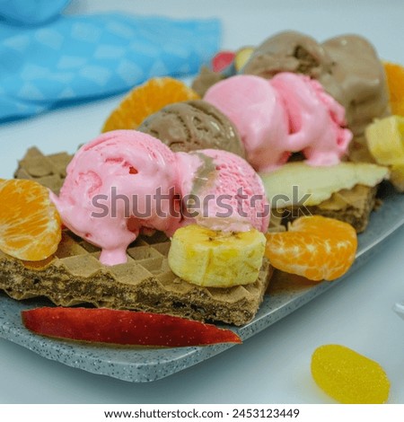 ice cream sundae with fruit topping, complete with wafers and candy