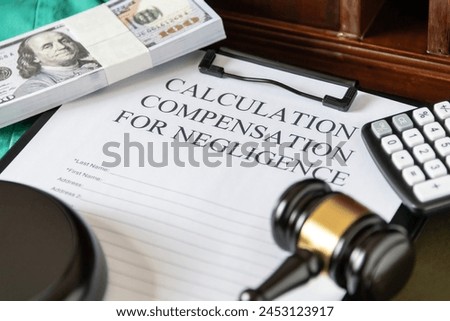 Legal document titled 'Calculation Compensation for Negligence' with a gavel and calculator, symbolizing judicial proceedings. Royalty-Free Stock Photo #2453123917