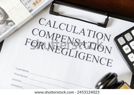 Legal document titled 'Calculation Compensation for Negligence' with a gavel and calculator, symbolizing judicial proceedings. Royalty-Free Stock Photo #2453124023