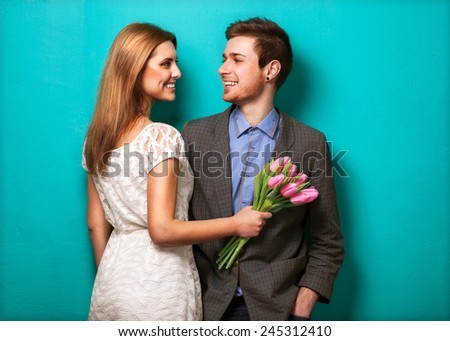 Beautiful couple in love with flowers tulips.Valentine's Day 