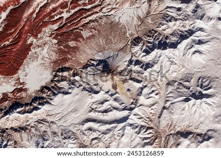 Activity at Kizimen Volcano. Widespread deposits of volcanic debris from frequent pyroclastic flows drape the slopes of Kizimen Volcano. Elements of this image furnished by NASA.
