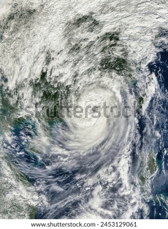 Typhoon Haima 25W over China. Typhoon Haima 25W over China. Elements of this image furnished by NASA. Royalty-Free Stock Photo #2453129061