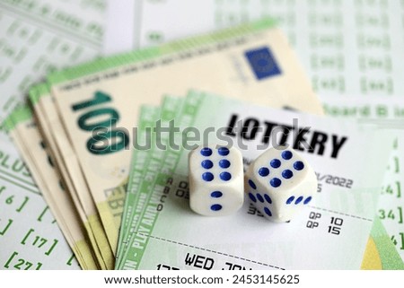 Green lottery tickets and euro money bills on blank with numbers for playing lottery close up