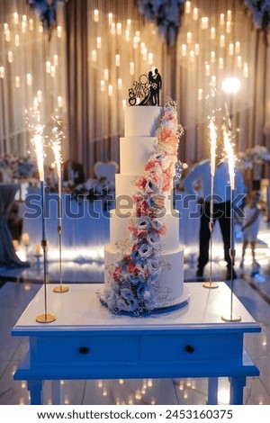 A picture of close up a wedding party cake with firework
