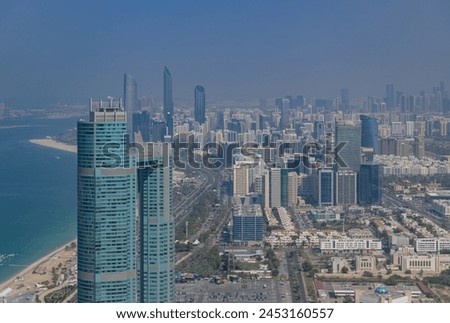 A picture of Downtown Abu Dhabi, with the St. Regis Abu Dhabi Hotel in the foreground, on the left side.