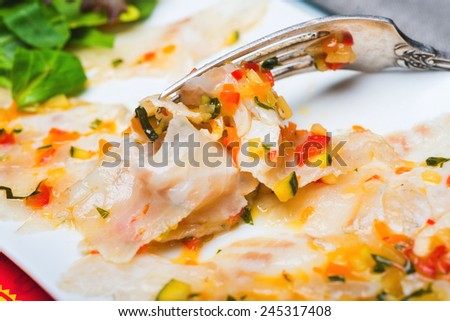 Marinated sea bass filet with ratatouille dressing, close up