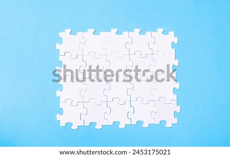 A puzzle piece is missing from a puzzle. Concept of emptiness and incompleteness Royalty-Free Stock Photo #2453175021