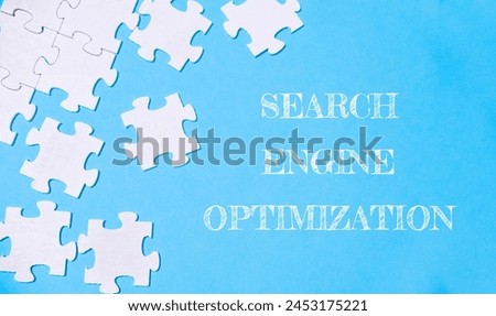 A puzzle with the words search engine optimization written on it. The puzzle pieces are scattered across the image, creating a sense of disarray and complexity
