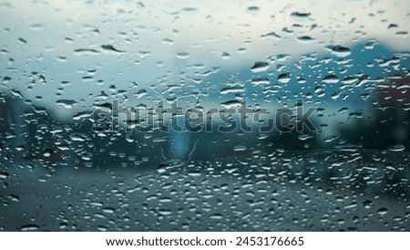 abstract background of raindrops on car windshield