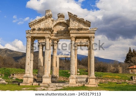 Ancient Tetrapylon ruins foreground the snow-capped mountains, showcasing Turkey's diverse beauty. Royalty-Free Stock Photo #2453179113