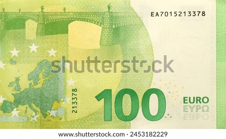 Fragment of one hundred euro money bill. Details of European union currency banknote of 100 euro close up