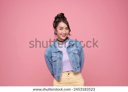 beautiful young Asia girl feel happiness with positive expression, joyful smile, dressed in casual cloth isolated on pink background.