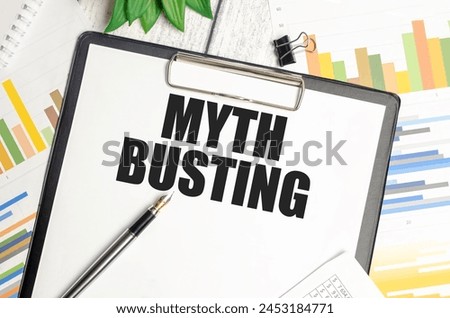 Clipboard with MYTH BUSTING inscription over graphs. Informative concept with copy space for educational poster or presentation. Royalty-Free Stock Photo #2453184771
