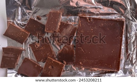 Milk chocolate made from high-quality cocoa. Cocoa and chocolos on white background, concept of price increase for raw materials of chocolate production.
