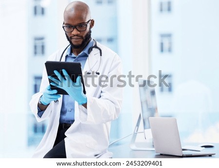 Healthcare, tablet or black man doctor in office for research, planning or hospital faq. Help, stethoscope or cardiovascular surgeon with digital communication, consulting or Telehealth service app Royalty-Free Stock Photo #2453209401