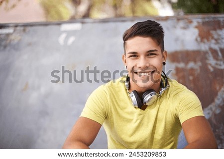 Smile, gen z and portrait of man at skatepark for skating practice or training for competition. Happy, fun and face of cool male person sitting on ramp with positive, good and confident attitude.