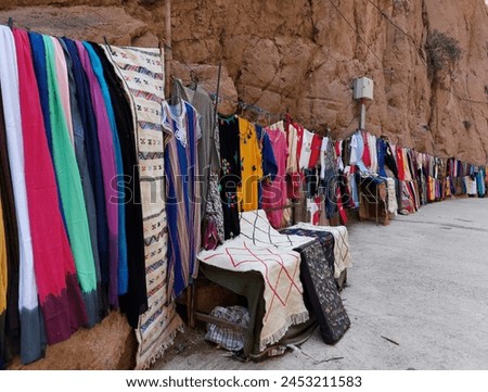On the way to the Upper Todgha Gorges in Tinerhir, there are valleys, trees, and winding roads. In the straits, many traditional clothes, jewelry, natural stones, and fossils are sold. Royalty-Free Stock Photo #2453211583