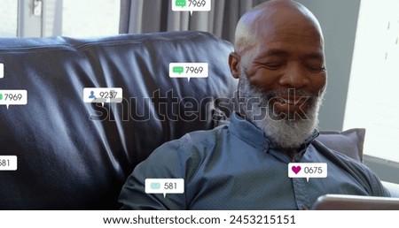 Image of notification bars over senior african american man using digital tablet at home. Digital composite, multiple exposure, childhood, social media reminder, retirement and technology concept. Royalty-Free Stock Photo #2453215151