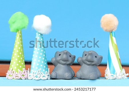 Tiny plastic elephants and birthday paper presents. Celebration. Children. Joy. Happy. Cheerful.