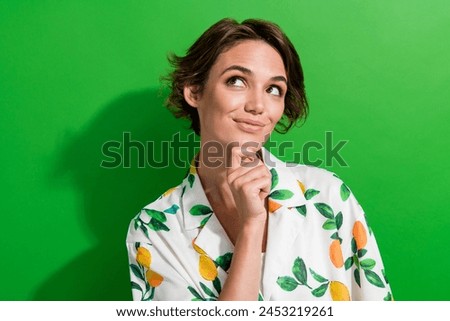 Photo of excited dreamy girl dressed print shirt arm chin looking empty space isolated green color background Royalty-Free Stock Photo #2453219261