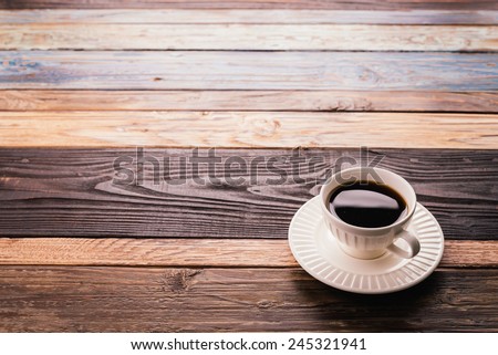Coffee cup on wooden background - vintage effect pictures