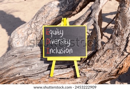 EDI equity diversity inclusion symbol. Concept words EDI equity diversity inclusion on yellow blackboard. Beautiful old tree background. Business EDI equity diversity inclusion concept. Copy space.