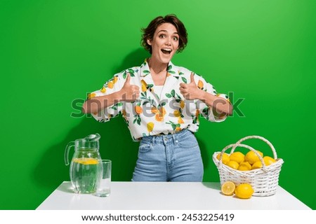Photo of positive young lady brown bob hair thumbs up good job feedback first receipt lemon water juice isolated on green color background Royalty-Free Stock Photo #2453225419