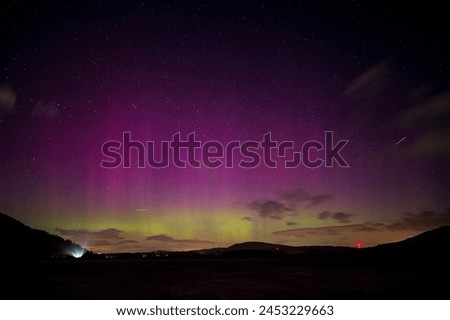 A stunning display of the northern lights over Bassenthwaite lake in the English Lake District Royalty-Free Stock Photo #2453229663