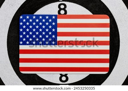 A picture of the American flag against the backdrop of darts target