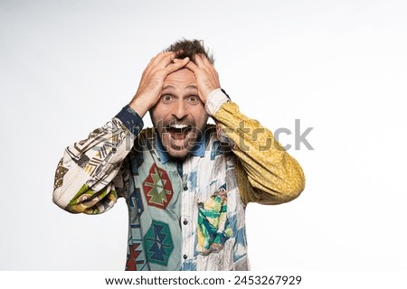 Exaggerated Surprise: Handsome Man in Colorful Casual Royalty-Free Stock Photo #2453267929