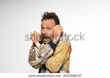 Comic Charm: Handsome Man in Colorful Casual with Exaggerated Gesture Royalty-Free Stock Photo #2453268127