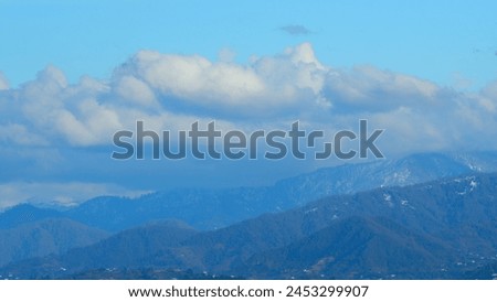 Snowy Hill With Moving Clouds Blown By The Wind. Beautiful Mountain Landscape In Winter.