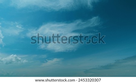 Soft White Clouds Moving On Blue Sky Background. Tropical Summer Or Spring Sunlight. No Birds And Free Of Defects Royalty-Free Stock Photo #2453320307