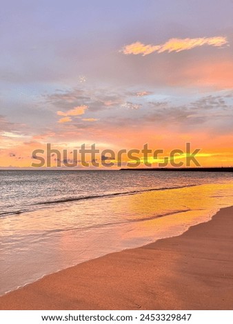 Beautiful Golden Sunset on the Beach of Bali. Tropical Paradise Beach with White Sands. Located in Kelan Beach, Bali - Indonesia Royalty-Free Stock Photo #2453329847
